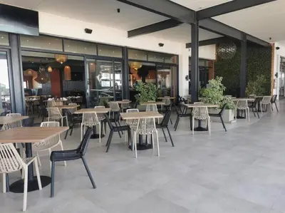 a restaurant with tables and chairs in a building at The Blyde Luxury Retreat in Pretoria