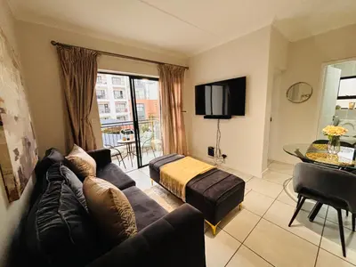 a living room with a couch and a bed at The Blyde Luxury Retreat in Pretoria