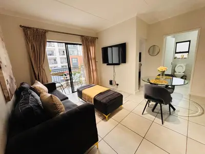 a living room with a couch and a table at The Blyde Luxury Retreat in Pretoria