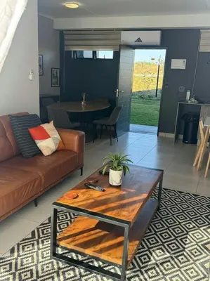 a living room with a couch and a table at Lakhe Lethu Apartment: Green Valley Estate in Nelspruit