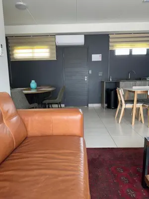 a living room with a couch and a table at Lakhe Lethu Apartment: Green Valley Estate in Nelspruit