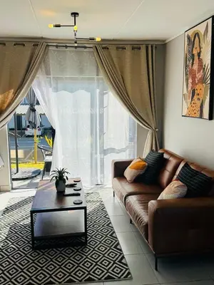 a living room with a couch and a coffee table at Lakhe Lethu Apartment: Green Valley Estate in Nelspruit