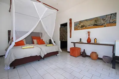 a bedroom with a bed with a canopy at Normann Safari Bush Lodge in Phalaborwa