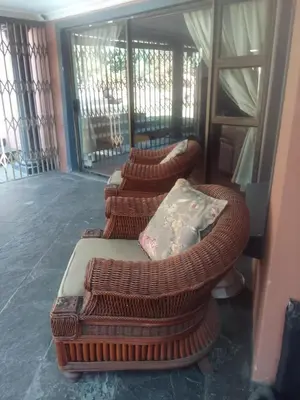 three wicker chairs with pillows sitting in a room at Room2rent Centurion in Pretoria