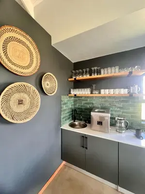 a kitchen with a sink and plates on the wall at Highland Gate Range View in Dullstroom