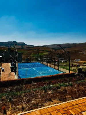 a swimming pool in the middle of a field at Highland Gate Range View in Dullstroom