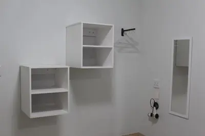 a white cabinet with shelves on a wall at Sunny Stay in Groblersdal