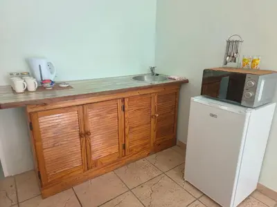 a kitchen with a counter with a microwave and a refrigerator at Sunny Stay in Groblersdal