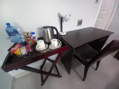 a small black table with a coffee maker on it at REALJOY GUEST SUITES in Centurion