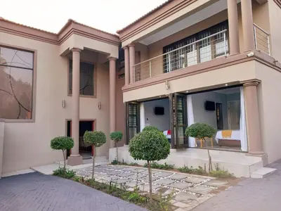 a house with trees in front of it at REALJOY GUEST SUITES in Centurion