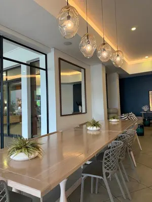 a dining room with a large wooden table and chairs at The Blyde in Pretoria