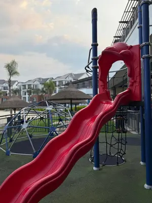 a playground with a red slide at a park at The Blyde in Pretoria
