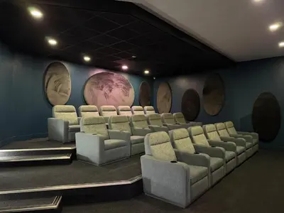 a cinema room with chairs and a wall with planets at The Blyde in Pretoria