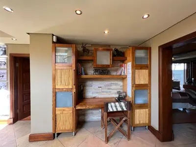 a room with a desk and a table with a chair at Pumula Bush Main House in Mabula