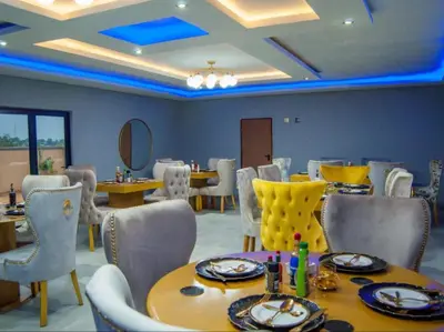 a dining room with a table and chairs at The Lux Hotel and Resorts in Louis Trichardt