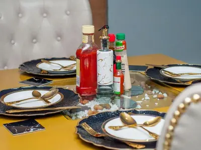 a table with plates and bottles ofetchup and mustard at The Lux Hotel and Resorts in Louis Trichardt