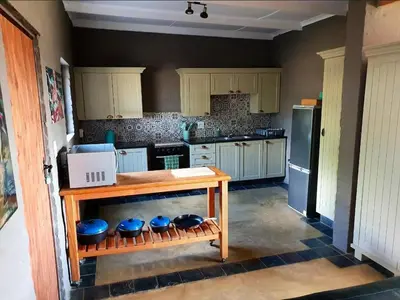 a kitchen with a table and some blue bowls at Horizon Savannah in Dinokeng Game Reserve