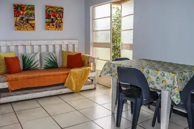 a dining room with a table and a couch at Panorama Chalets & Rest Camp in Graskop