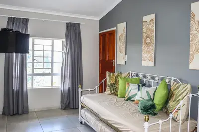 a living room with a couch and a window at Panorama Chalets & Rest Camp in Graskop