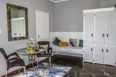 a living room with a table and a couch at Panorama Chalets & Rest Camp in Graskop