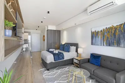 a bedroom with a bed and a couch at Ellipse Waterfall 31002 in Midrand