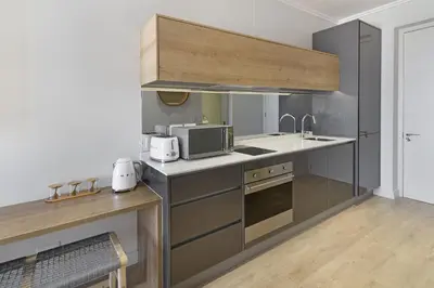 a kitchen with a sink and a microwave at Ellipse Waterfall 31002 in Midrand