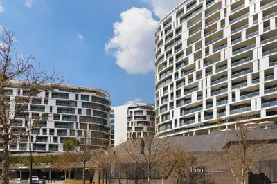 two tall buildings with trees in front of them at Ellipse Waterfall 31002 in Midrand