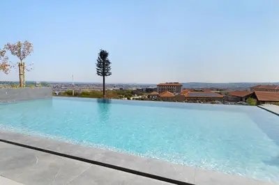 a large swimming pool with a view of the city at Ellipse Waterfall 31002 in Midrand