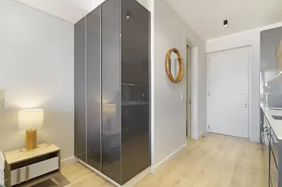 a glass shower in a bedroom with a table and a mirror at Ellipse Waterfall 31015 in Midrand