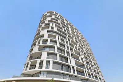 a tall apartment building against a blue sky at Ellipse Waterfall 31015 in Midrand