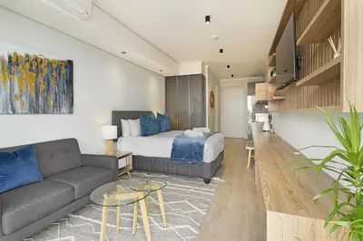 a living room with a bed and a couch at Ellipse Waterfall 31015 in Midrand