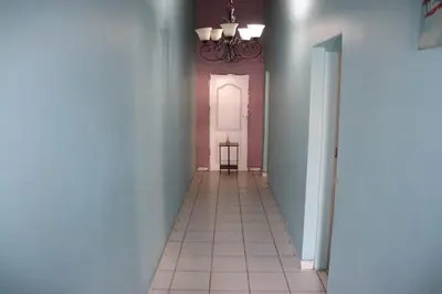 a hallway with a door and a tile floor at Unitrainview guest house in Pretoria