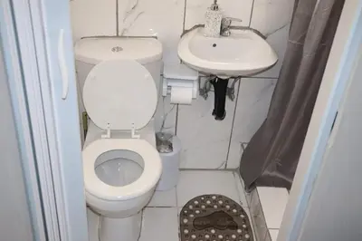 a small bathroom with a toilet and a sink at Unitrainview guest house in Pretoria