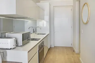 a white kitchen with a sink and a microwave at Ellipse Waterfall 3902 in Midrand