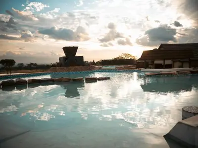 a large pool of water in front of a building at Shekinah Lion & Game Lodge in Dryfsand