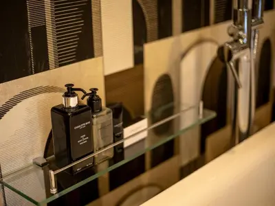 a bathroom with a soap dispenser on a mirror at Shekinah Lion & Game Lodge in Dryfsand