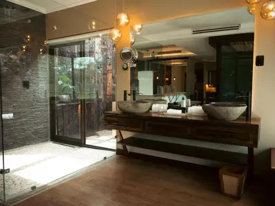 a bathroom with two sinks and a large mirror at Shekinah Lion & Game Lodge in Dryfsand
