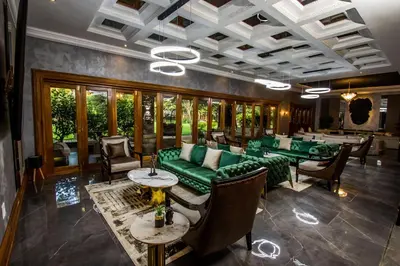 a living room with green couches and tables at Mekete Boutique & Events in Polokwane