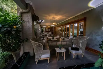 a restaurant with wicker chairs and couches on a patio at Mekete Boutique & Events in Polokwane