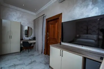 a living room with a television and a desk in a room at Mekete Boutique & Events in Polokwane
