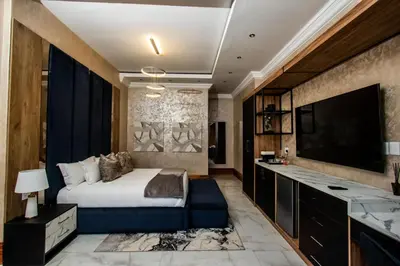 a bedroom with a bed and a flat screen tv at Mekete Boutique & Events in Polokwane