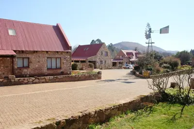 an empty road in front of some buildings at Mountain View Cottage in Dullstroom