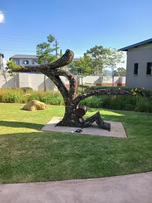 a statue of a woman in boots on the grass at Spacious 2 Bedroom Apartment in Carslwald, Midrand - Business and Family friendly - 2 Elizabeth Place in Midrand