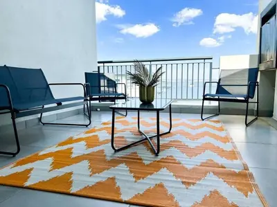 a balcony with chairs and a table on a rug at Spacious 2 Bedroom Apartment in Carslwald, Midrand - Business and Family friendly - 2 Elizabeth Place in Midrand
