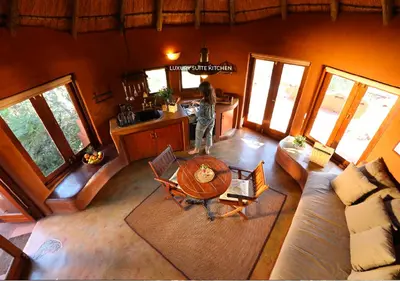a person standing in a living room with a table at Leshiba Wilderness in Louis Trichardt