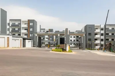 an empty parking lot in front of a large building at The Blissful Abode by BK Hospitable in Midrand