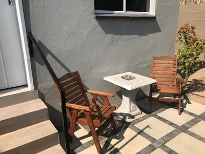 two chairs and a table on a patio at Red Lotus Studio Pta East-No Loadshedding in Pretoria
