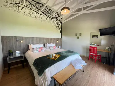 a bedroom with a large bed with a tray on it at Khululeka Safaris Lodge in White River