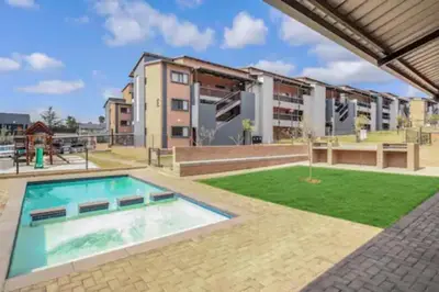 an image of an apartment complex with a swimming pool at The Place @ Mall of Africa in Midrand