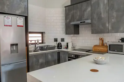 a kitchen with stainless steel appliances and a counter top at Rand Corner Crib in Pretoria